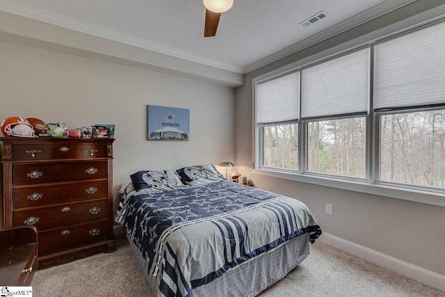 carpeted bedroom featuring ceiling fan and ornamental molding