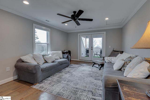 living room featuring crown molding, hardwood / wood-style floors, and a wealth of natural light