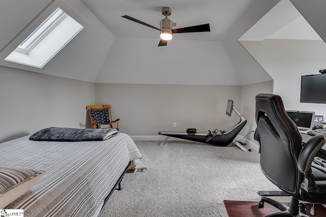 bedroom with ceiling fan, vaulted ceiling with skylight, and carpet flooring