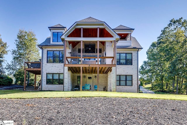 view of front of property featuring a front lawn and a balcony