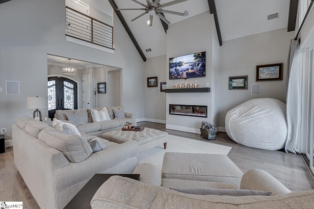 living room featuring high vaulted ceiling, ceiling fan, french doors, and light hardwood / wood-style floors