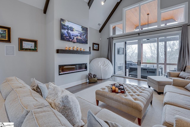 living room featuring hardwood / wood-style flooring, high vaulted ceiling, and beam ceiling