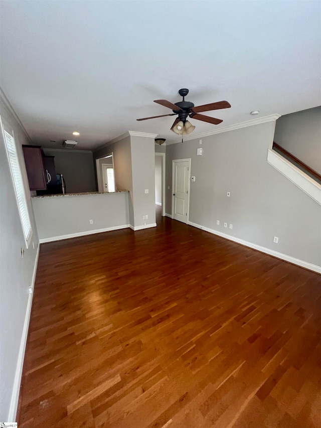 unfurnished living room featuring ceiling fan, ornamental molding, and dark hardwood / wood-style flooring