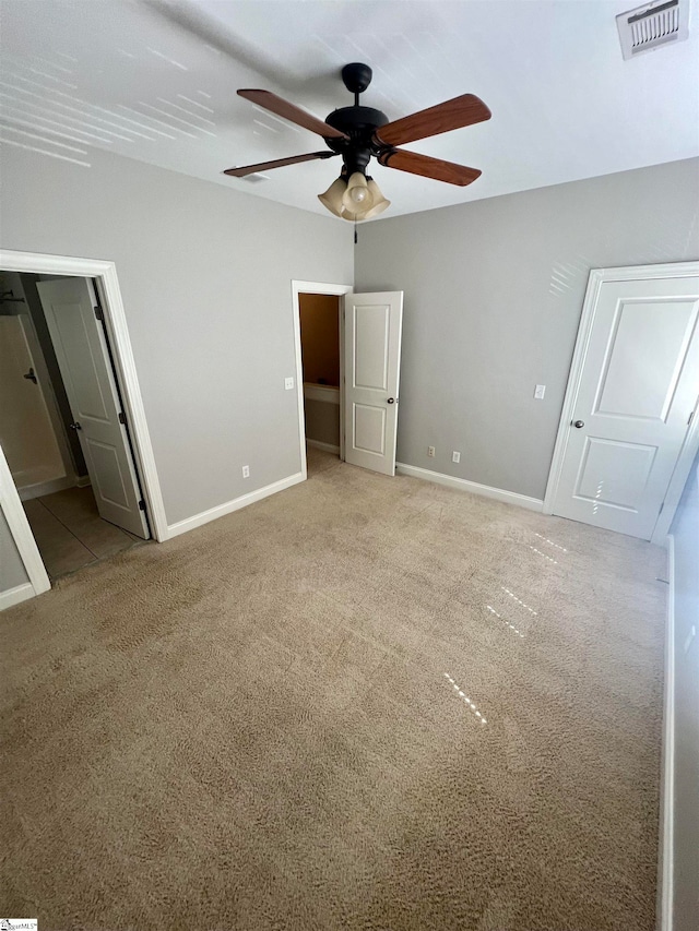 unfurnished bedroom with ceiling fan and light colored carpet