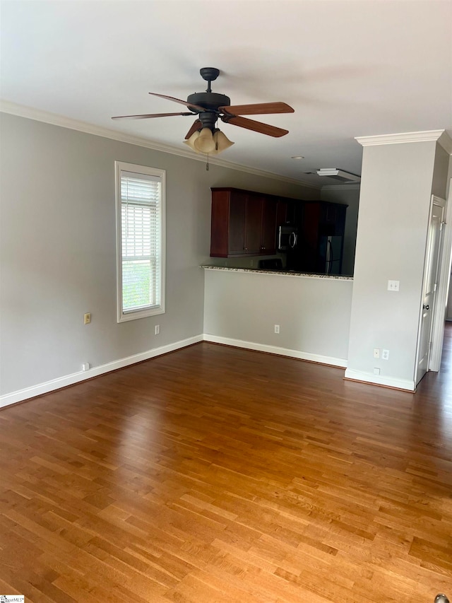 unfurnished living room with ceiling fan, light wood-type flooring, and ornamental molding