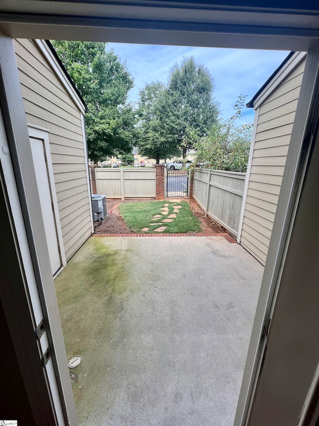 view of yard with cooling unit and a patio area