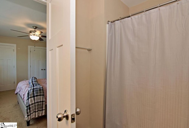 bathroom with ceiling fan and a shower with shower curtain