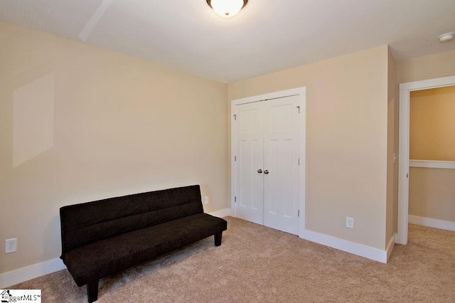 sitting room featuring light colored carpet