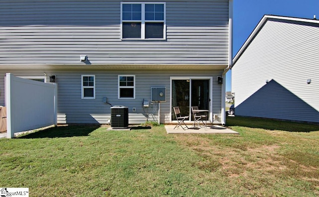 rear view of property featuring a patio, a lawn, and central AC unit