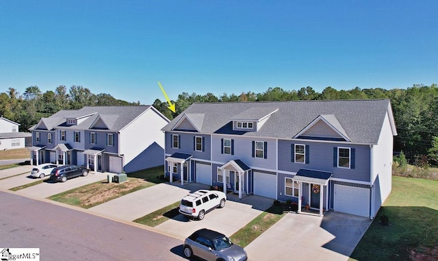 townhome / multi-family property featuring a garage