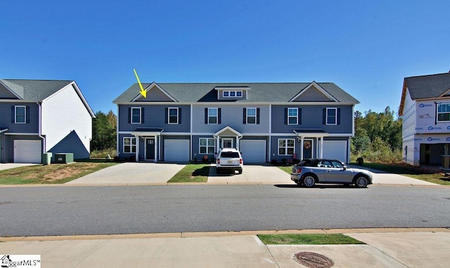 view of front of house with central AC unit and a garage