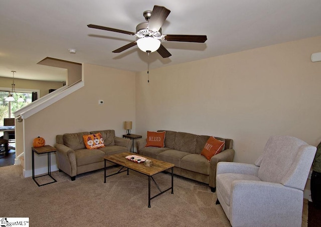 living room featuring ceiling fan and light colored carpet