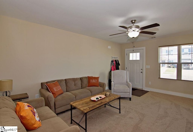 carpeted living room with ceiling fan