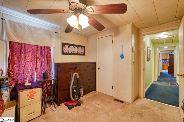 misc room featuring light carpet, ornamental molding, and ceiling fan