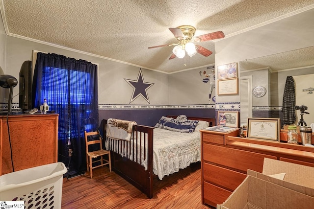 bedroom with ceiling fan, a textured ceiling, crown molding, and hardwood / wood-style floors