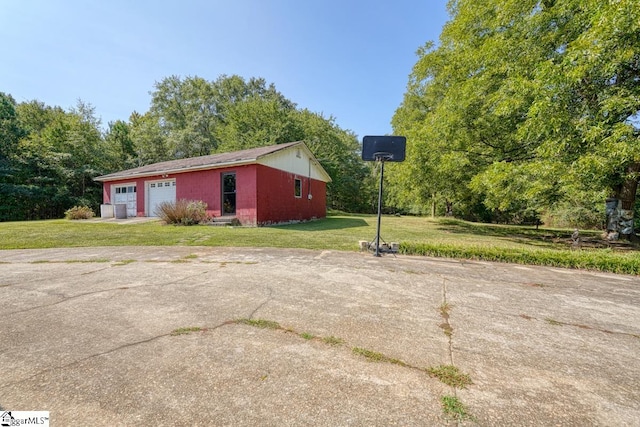 exterior space featuring a garage and a yard