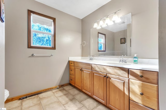 bathroom featuring tile patterned flooring, vanity, and toilet