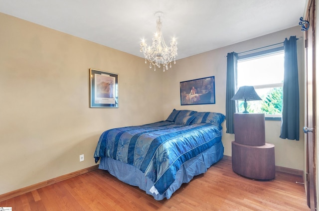 bedroom featuring wood-type flooring and a chandelier