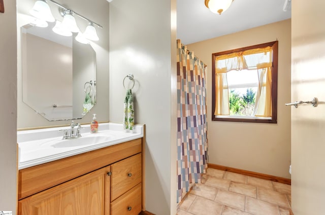 bathroom with tile patterned floors, vanity, and curtained shower