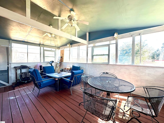 sunroom with ceiling fan, vaulted ceiling, and a wealth of natural light