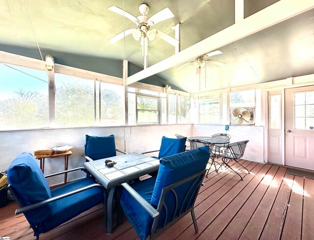 sunroom / solarium with ceiling fan and lofted ceiling