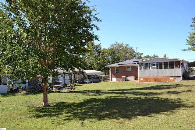 view of yard featuring a sunroom