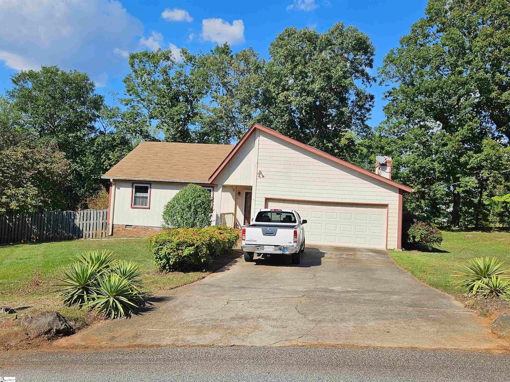 single story home featuring a garage and a front lawn