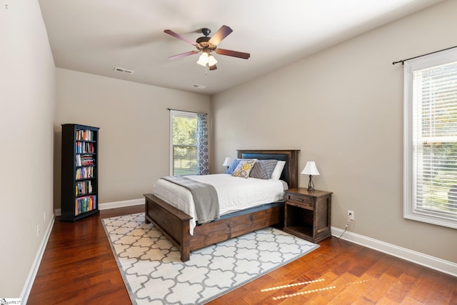 bedroom with wood-type flooring, multiple windows, and ceiling fan