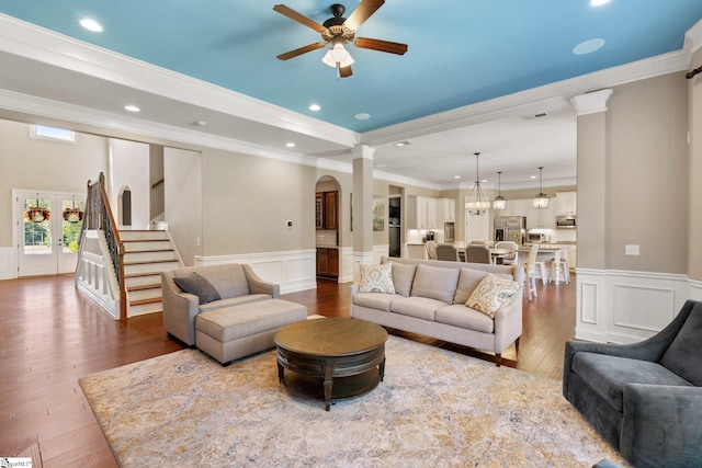 living room with french doors, wood-type flooring, ornamental molding, and ceiling fan