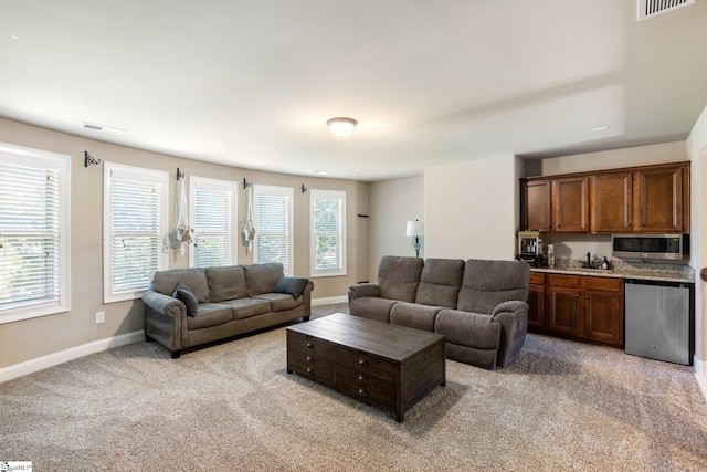 carpeted living room featuring sink