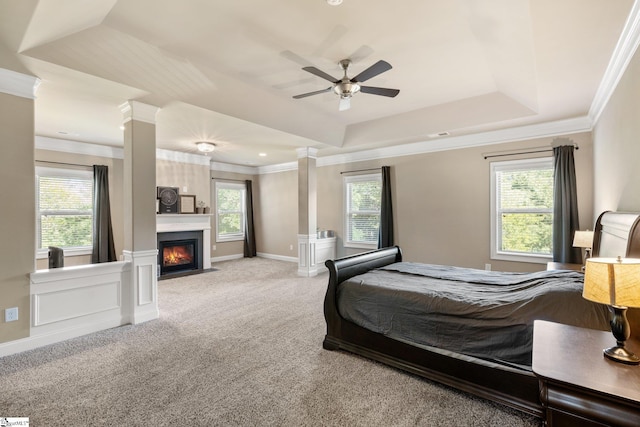 bedroom with decorative columns, carpet, multiple windows, and ceiling fan