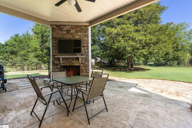 view of patio / terrace featuring an outdoor stone fireplace and ceiling fan