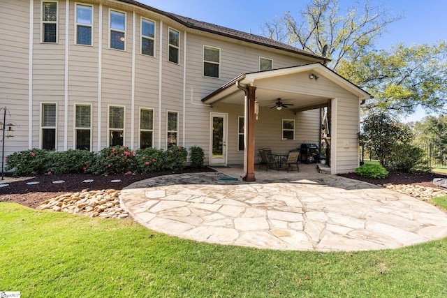 rear view of house featuring a lawn, a patio area, and ceiling fan