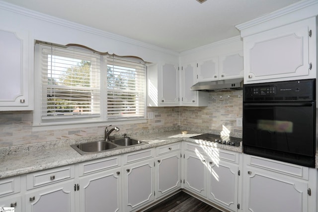 kitchen featuring white cabinets, black appliances, sink, and backsplash