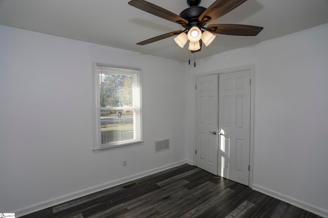 unfurnished room featuring ceiling fan and dark hardwood / wood-style flooring