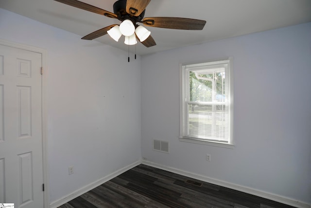 empty room featuring dark wood-type flooring and ceiling fan