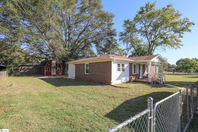 view of home's exterior with a storage shed and a lawn