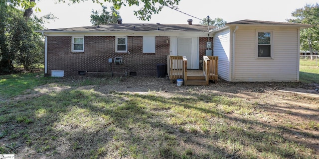 rear view of house with a yard