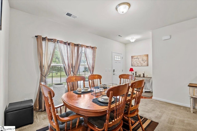 dining room featuring light colored carpet