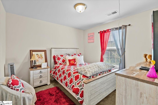 bedroom with dark colored carpet