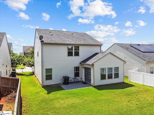 rear view of house with a lawn and a patio area