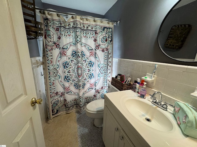 full bathroom with tile walls, toilet, vanity, and shower / bath combo