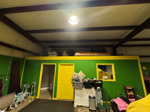 bedroom featuring carpet and beam ceiling