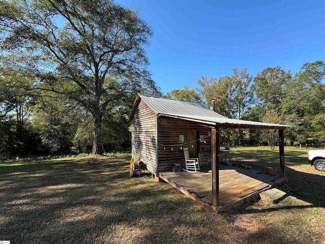 view of outbuilding featuring a lawn