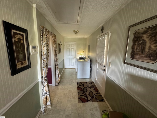 hallway featuring crown molding and a textured ceiling