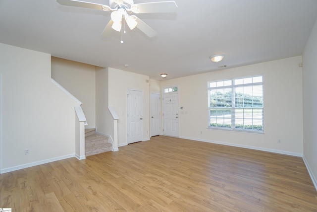 unfurnished living room with ceiling fan and light hardwood / wood-style flooring