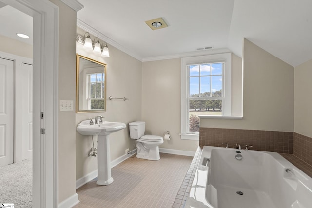 bathroom featuring toilet, a washtub, tile patterned floors, sink, and lofted ceiling