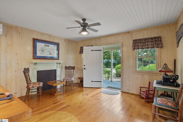 10490 New Cut Rd, Campobello, SC 29322 - sitting room with wooden walls, ceiling fan, wood finished floors, and a fireplace