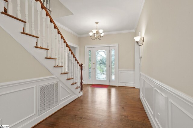 10490 New Cut Rd, Campobello, SC 29322 - foyer entrance featuring a chandelier, a decorative wall, stairs, a wainscoted wall, and wood finished floors