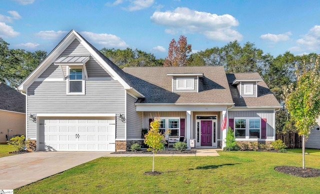 view of front facade with a front yard, a garage, and covered porch